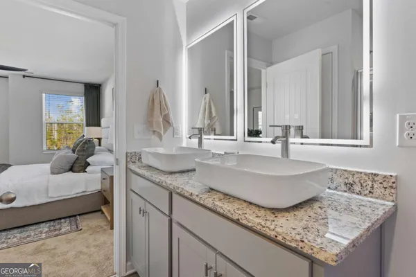 a bathroom with sinks granite countertop a sink and a mirror