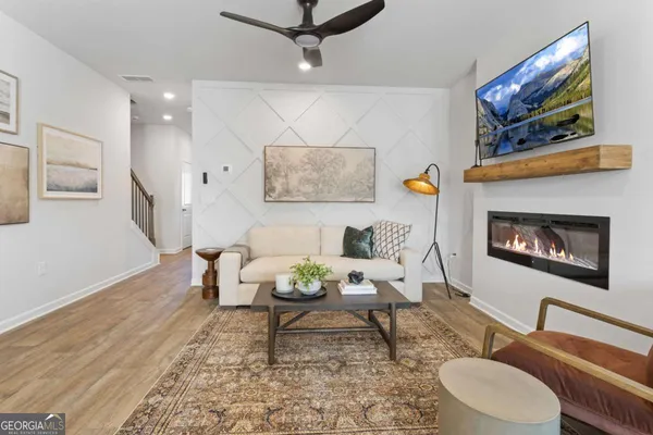 a living room with furniture and a wooden floor