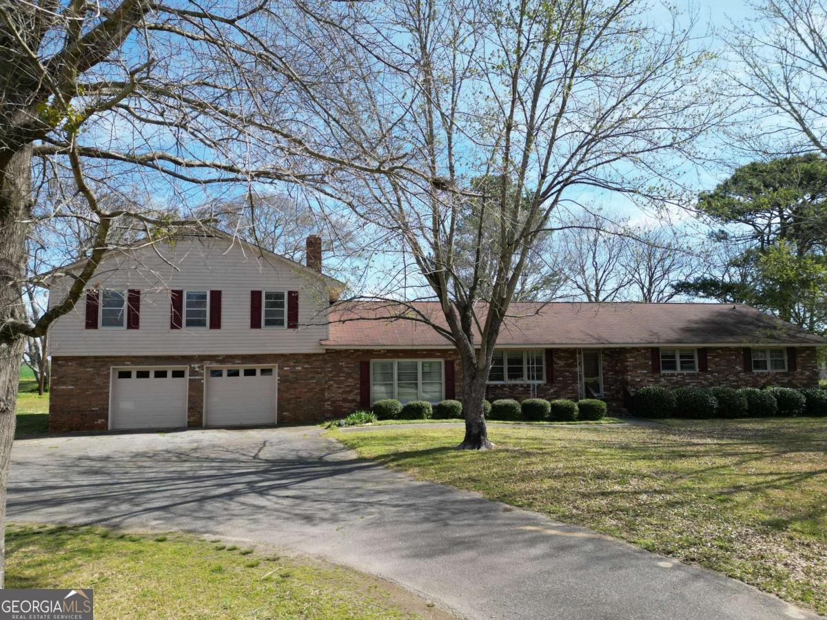 6071 Bostwick Road Bishop, GA 30621 - Photo 1 of 1 a front view of a house with a yard