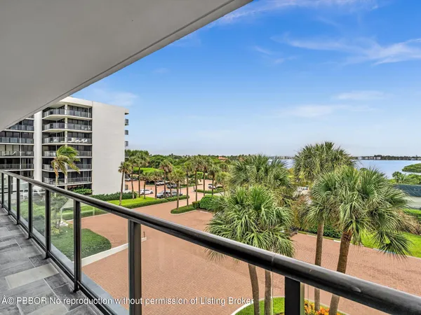 a spacious bathroom with a tub sink double vanity granite and a bathtub