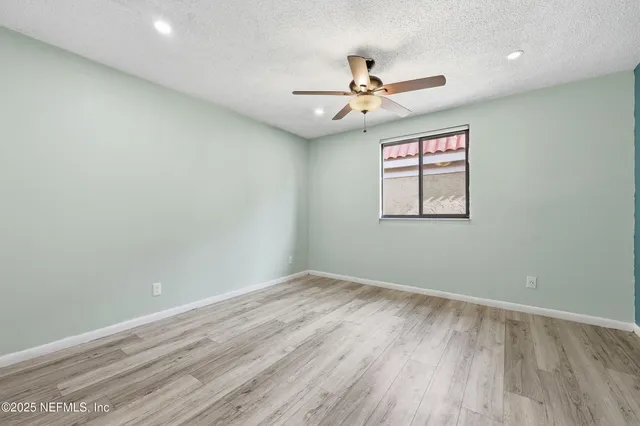 a room with pool table and windows