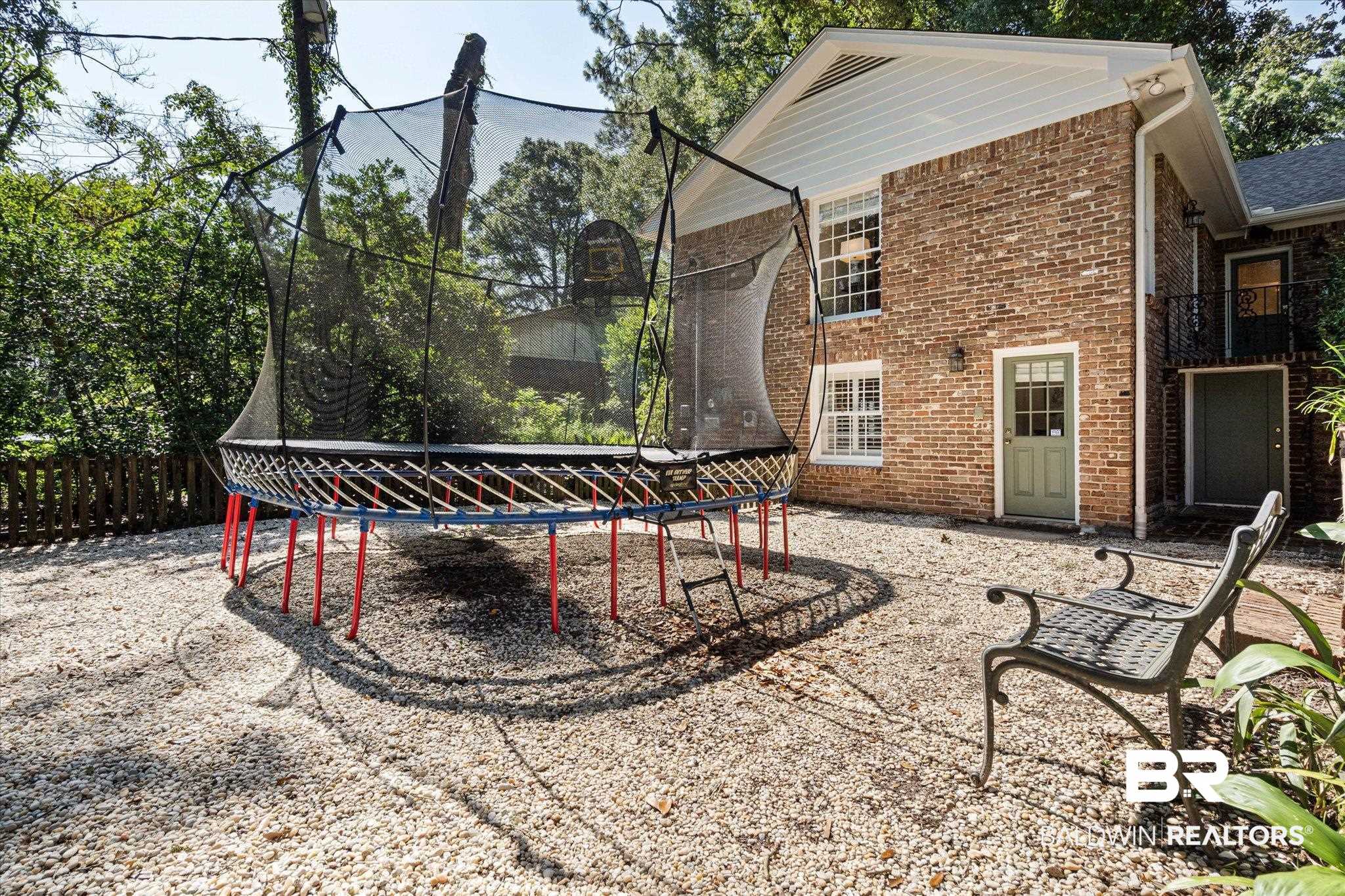 3612 Linden Lane Mobile, AL 36608 - Photo 38 of 42 Back of property with a trampoline and brick siding