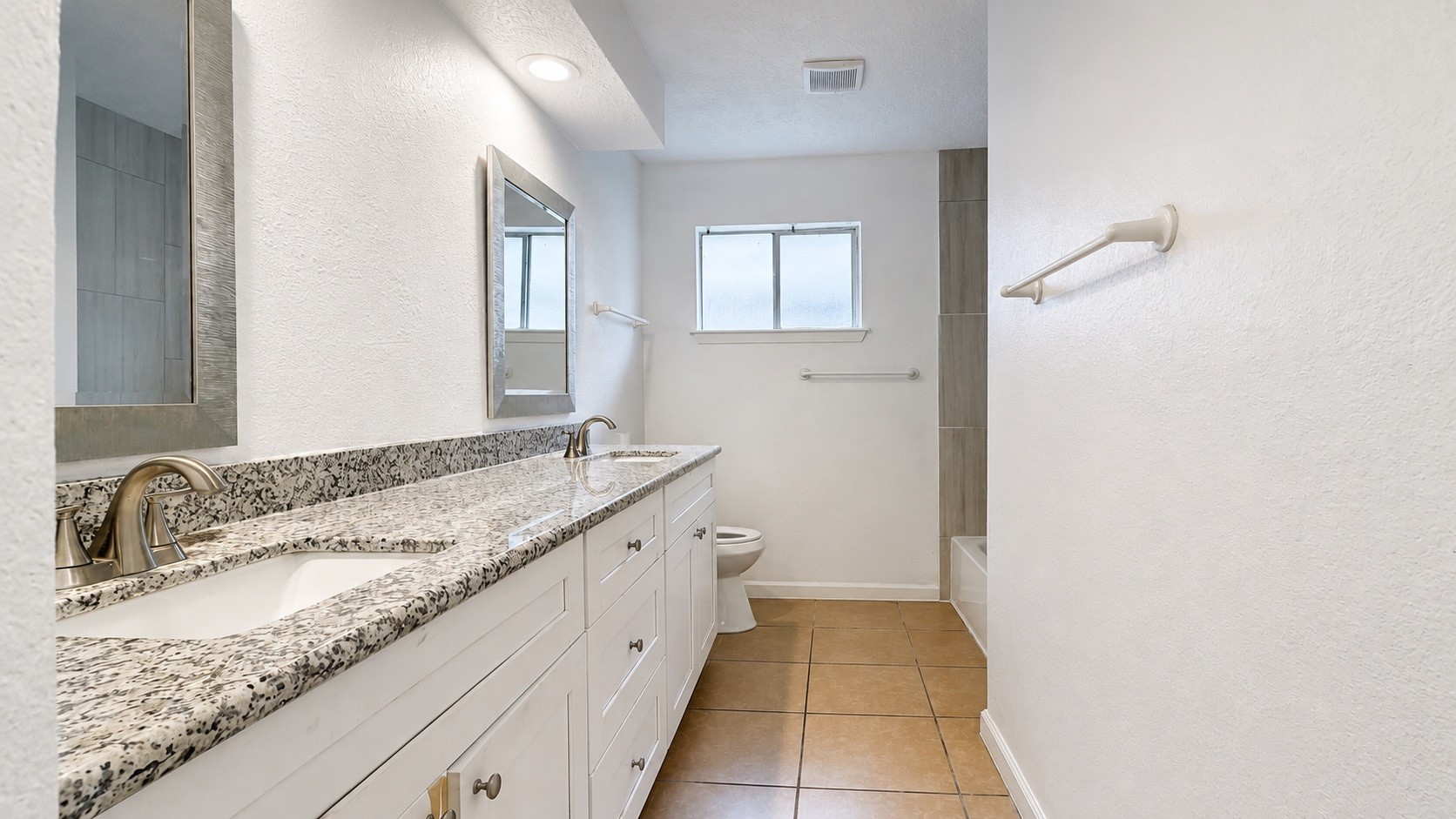 4418 Ponca Street Pasadena, TX 77504 - Photo 16 of 23 Secondary bathroom with granite vanity space and a clean tub/shower setup. (image has been enhance for marketing purposes)
