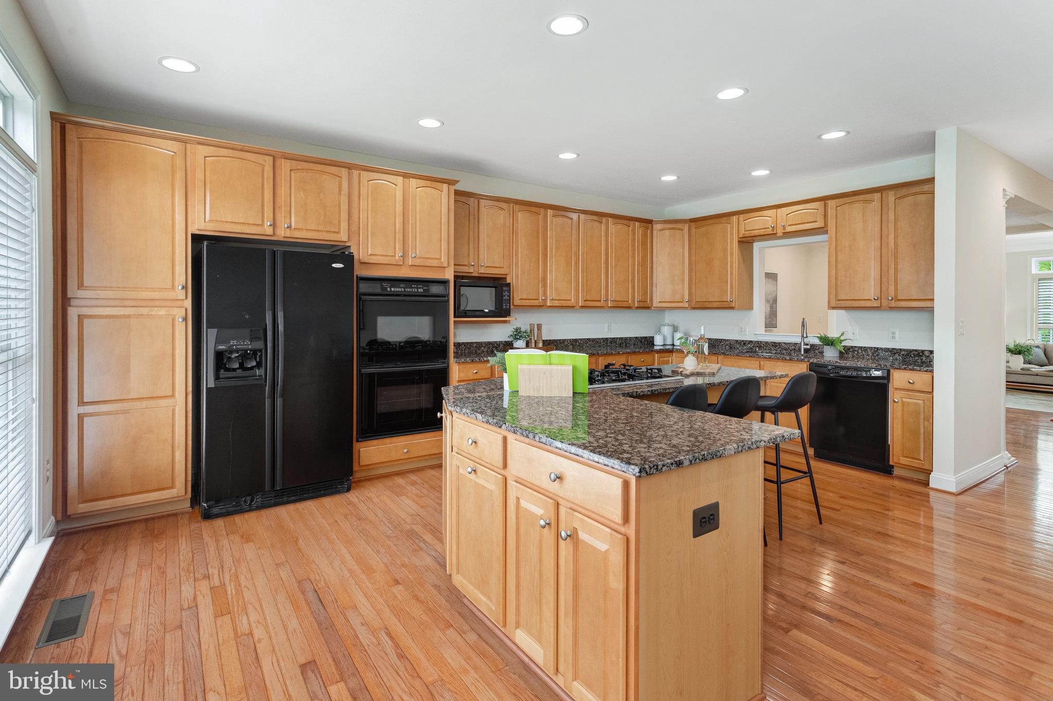 25804 Commons Square Chantilly, VA 20152 - Photo 12 of 48 a kitchen with stainless steel appliances granite countertop a refrigerator and a stove top oven