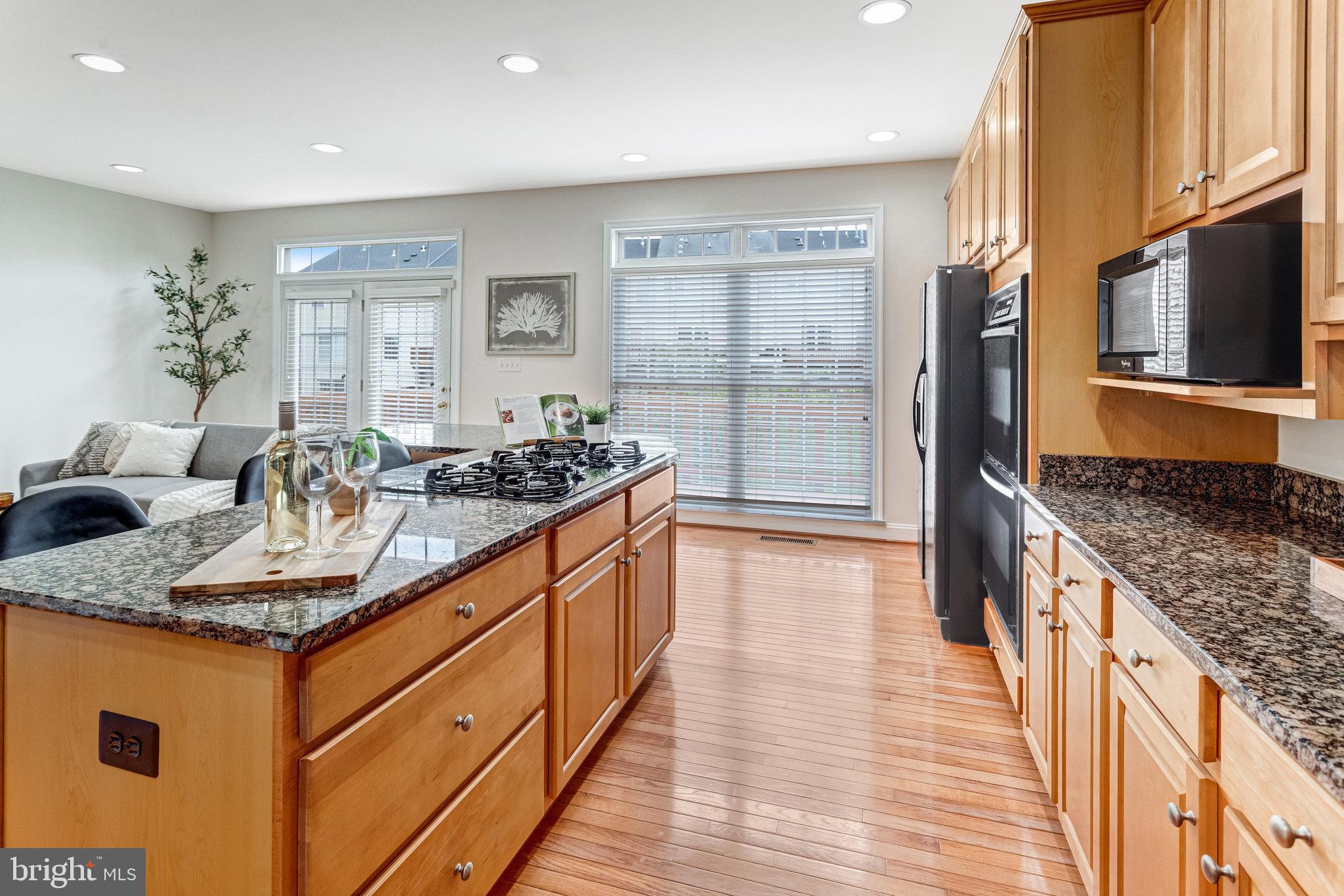 25804 Commons Square Chantilly, VA 20152 - Photo 14 of 48 a kitchen with granite countertop a sink and cabinets