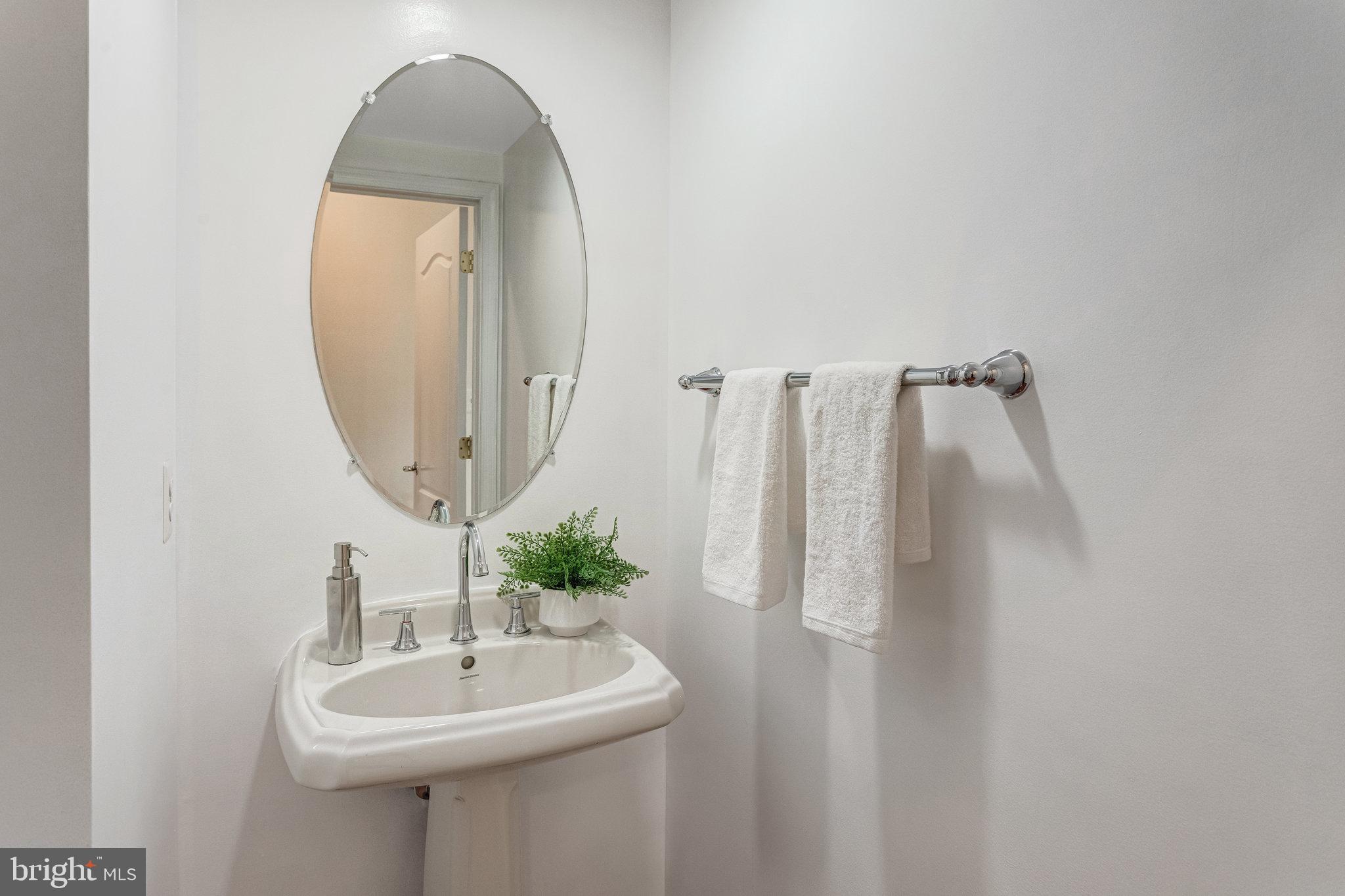 25804 Commons Square Chantilly, VA 20152 - Photo 16 of 48 a bathroom with a sink a mirror and a shower