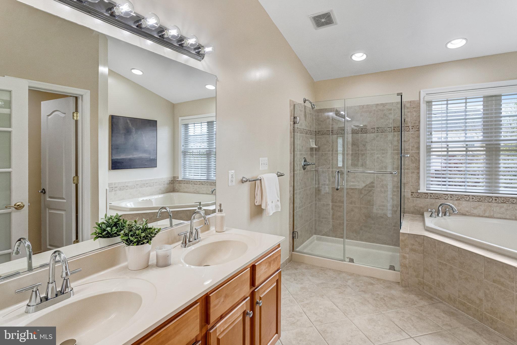 25804 Commons Square Chantilly, VA 20152 - Photo 21 of 48 a bathroom with a granite countertop sink mirror and shower