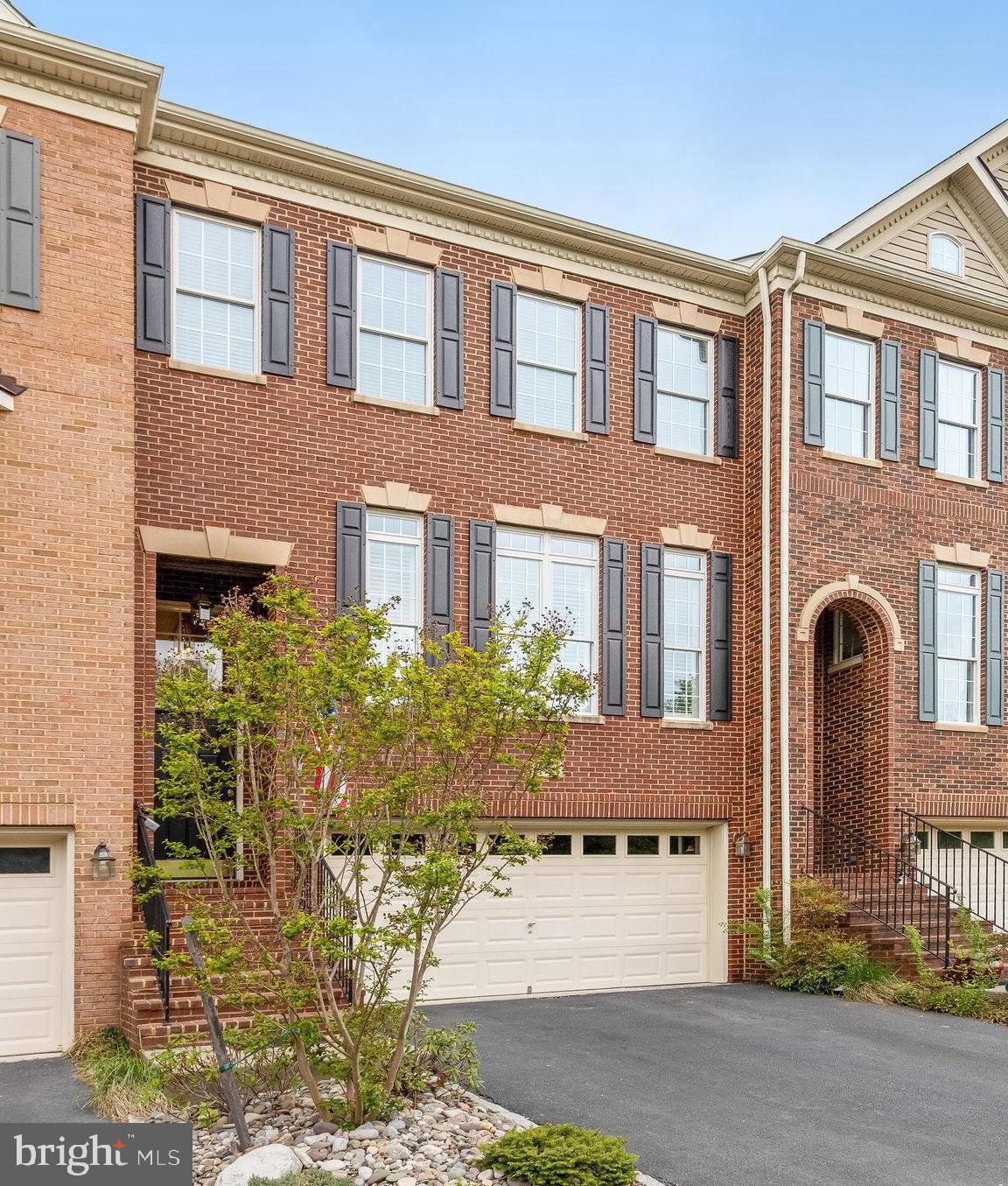 25804 Commons Square Chantilly, VA 20152 - Photo 3 of 48 a front view of a house with a garden