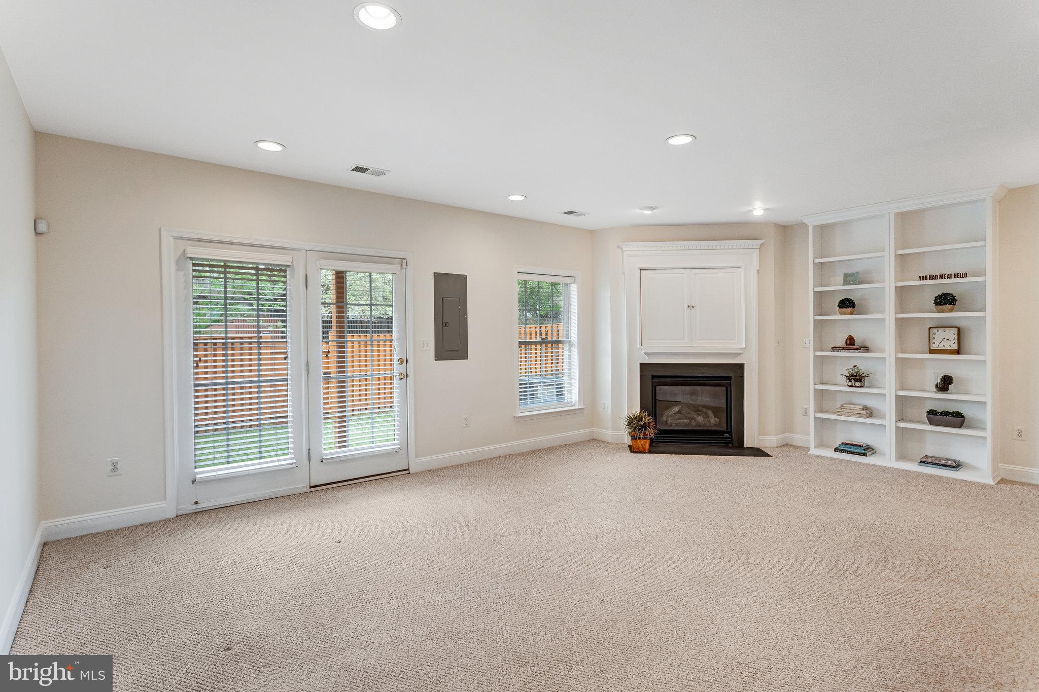 25804 Commons Square Chantilly, VA 20152 - Photo 31 of 48 a view of an empty room with a fireplace and a window