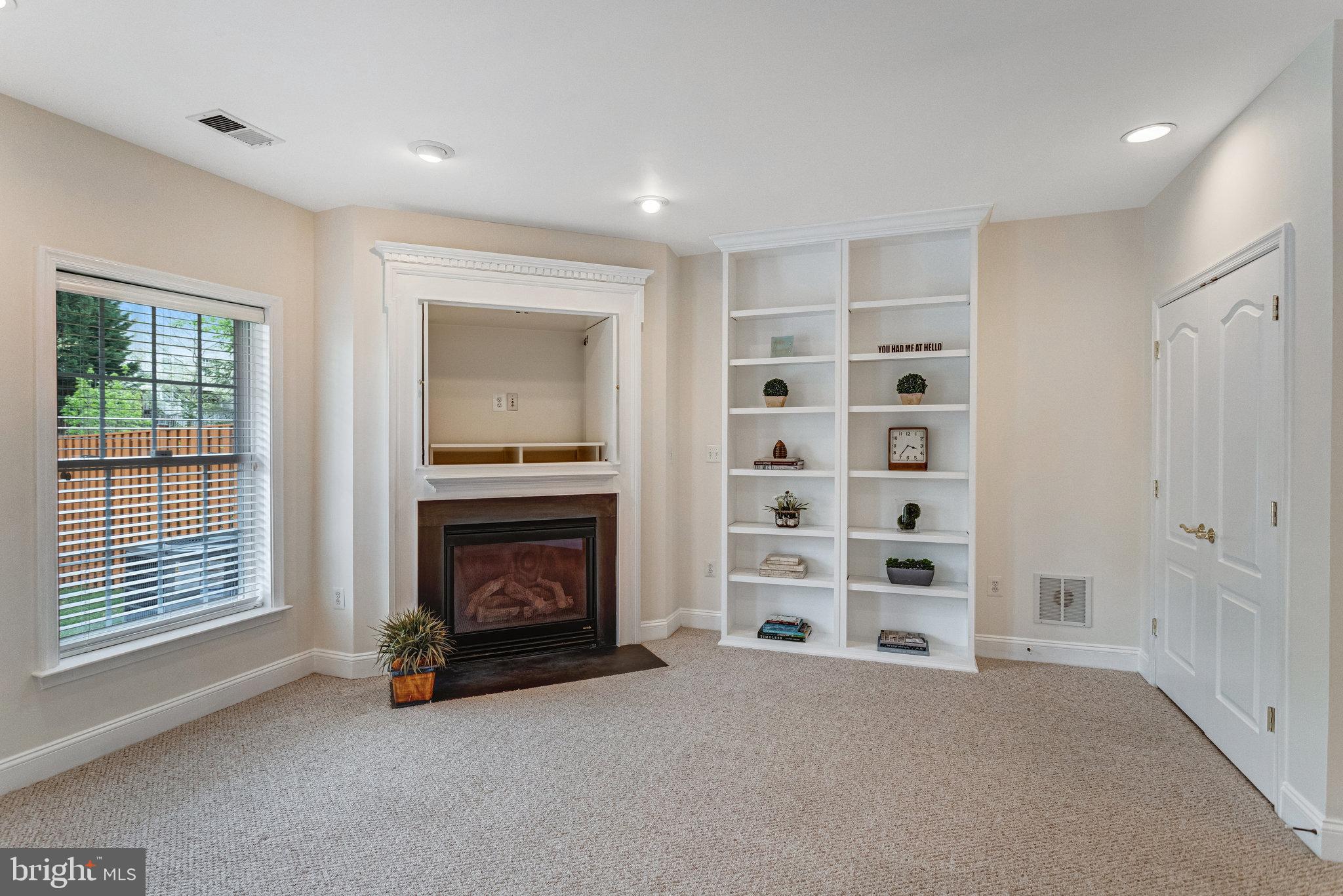 25804 Commons Square Chantilly, VA 20152 - Photo 32 of 48 a view of an empty room with a fireplace and a window