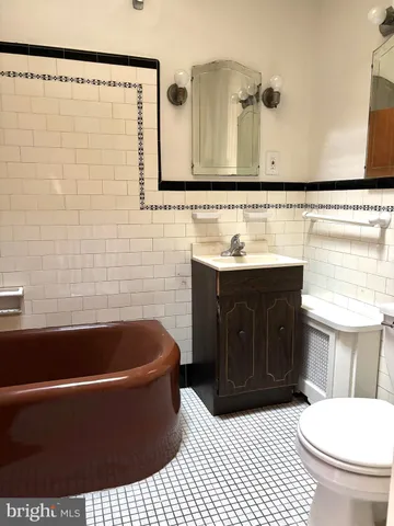 a bathroom with a sink a toilet and bathtub