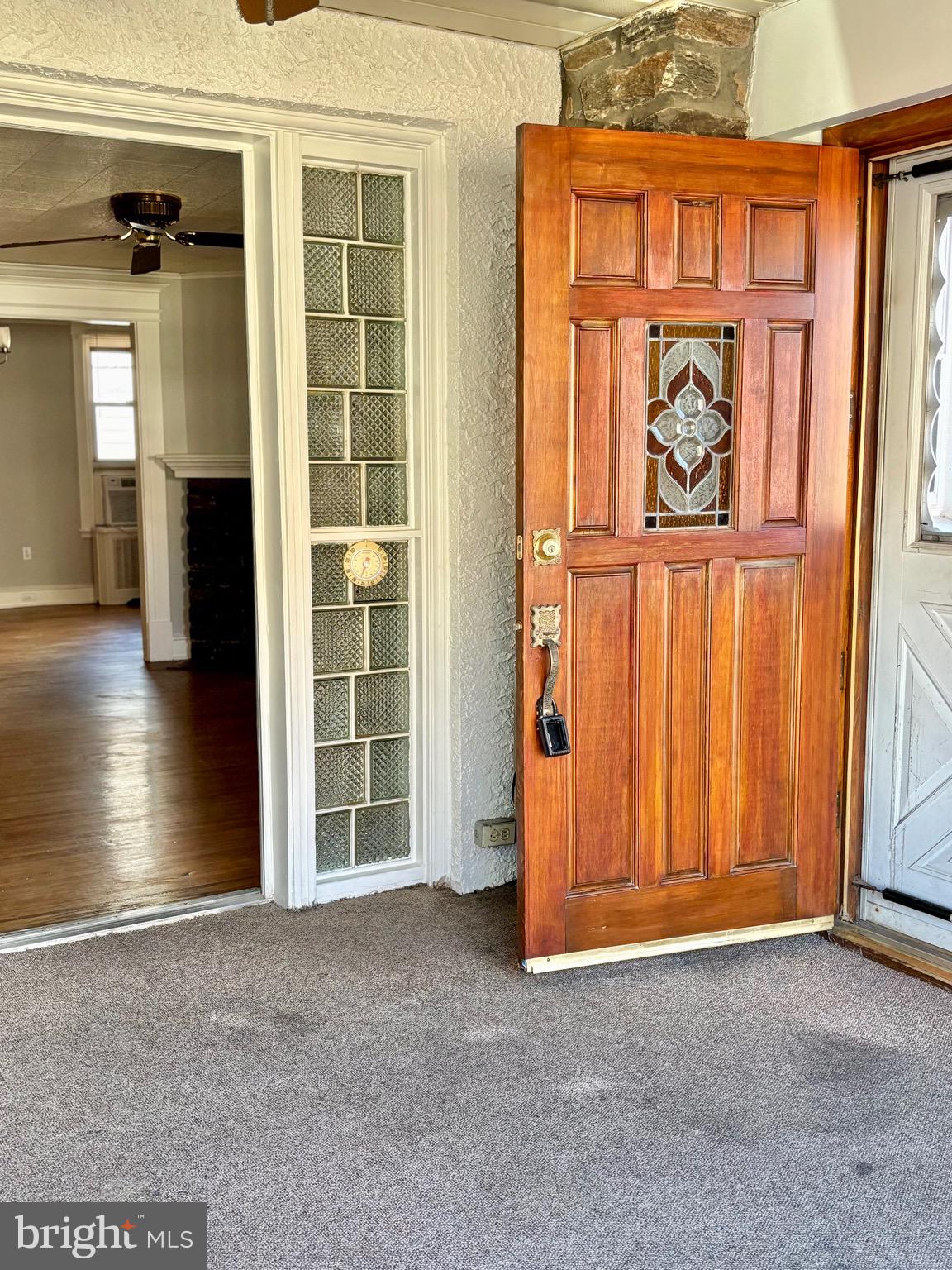 7242 Brent Road Upper Darby, PA 19082 - Photo 2 of 14 an empty room with windows wooden wall and door