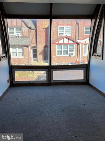 a view of an empty room with windows