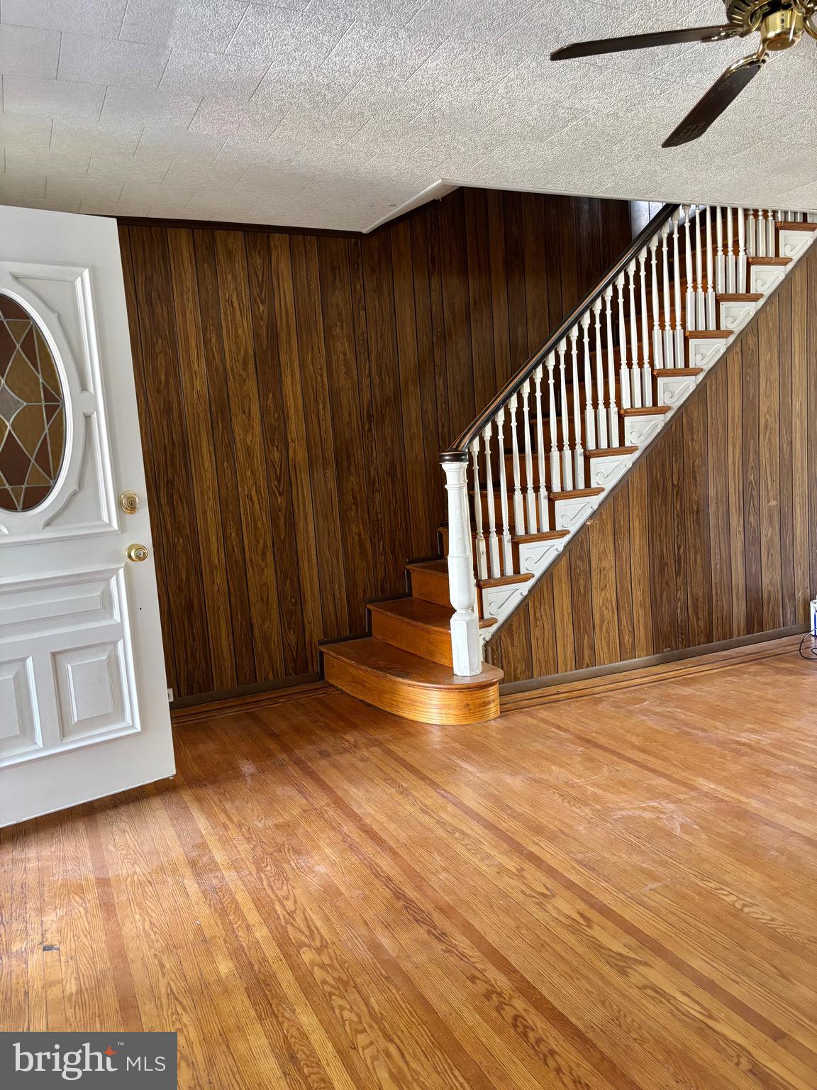 7242 Brent Road Upper Darby, PA 19082 - Photo 4 of 14 a view of a hallway with wooden floor and staircase
