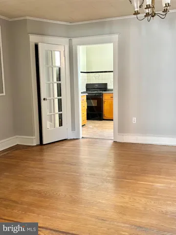 a view of a livingroom with wooden floor and a fireplace