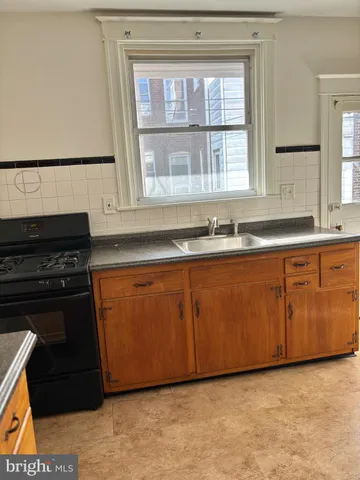 a kitchen with granite countertop a sink and a stove