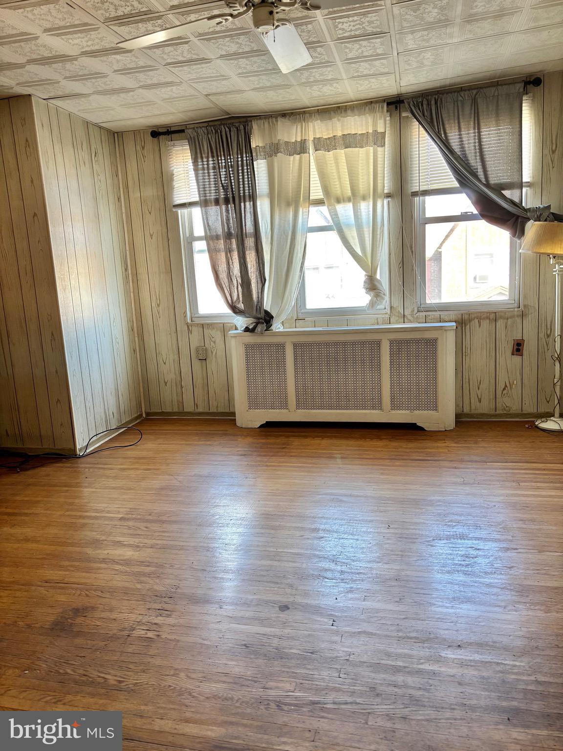 7242 Brent Road Upper Darby, PA 19082 - Photo 9 of 14 a view of empty room with wooden floor and fan