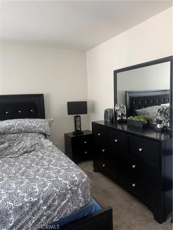 a bedroom with a bed and a dresser