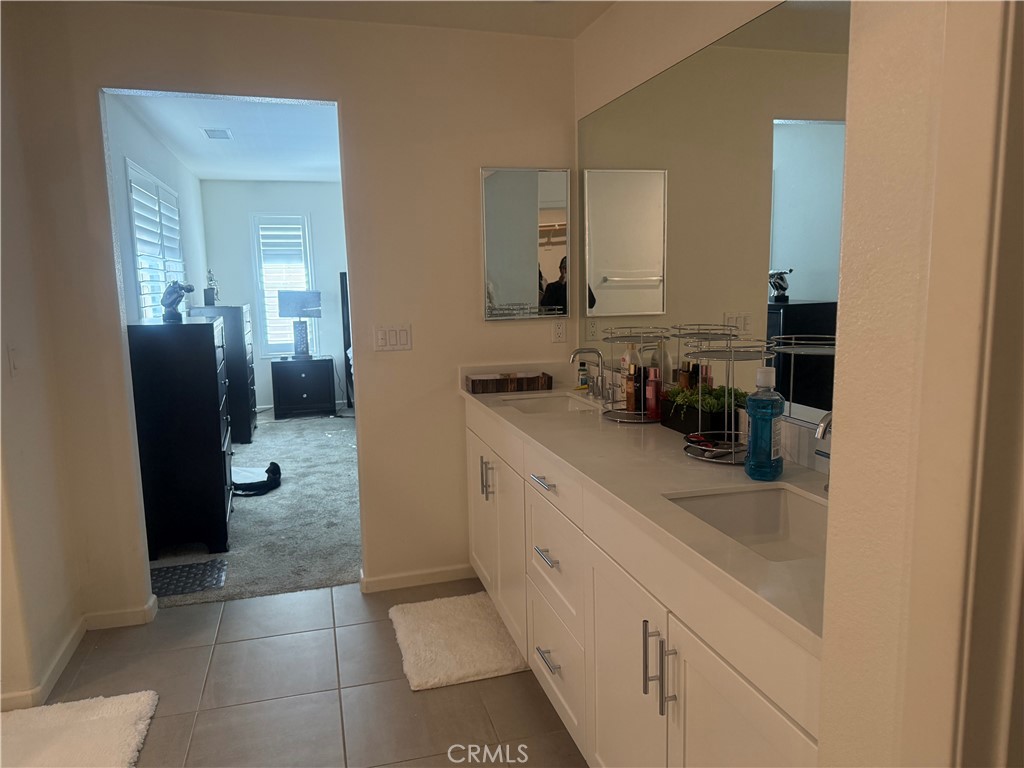 467 West Buttercup Lane Rialto, CA 92376 - Photo 3 of 13 a bathroom with a double vanity sink and a mirror
