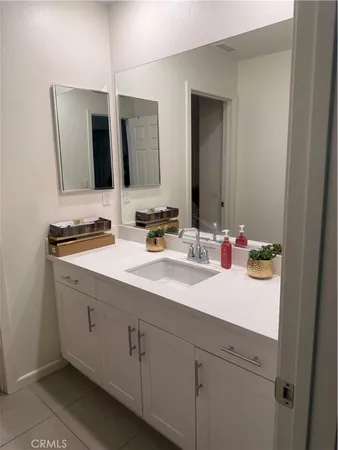 a bathroom with double sink and a mirror
