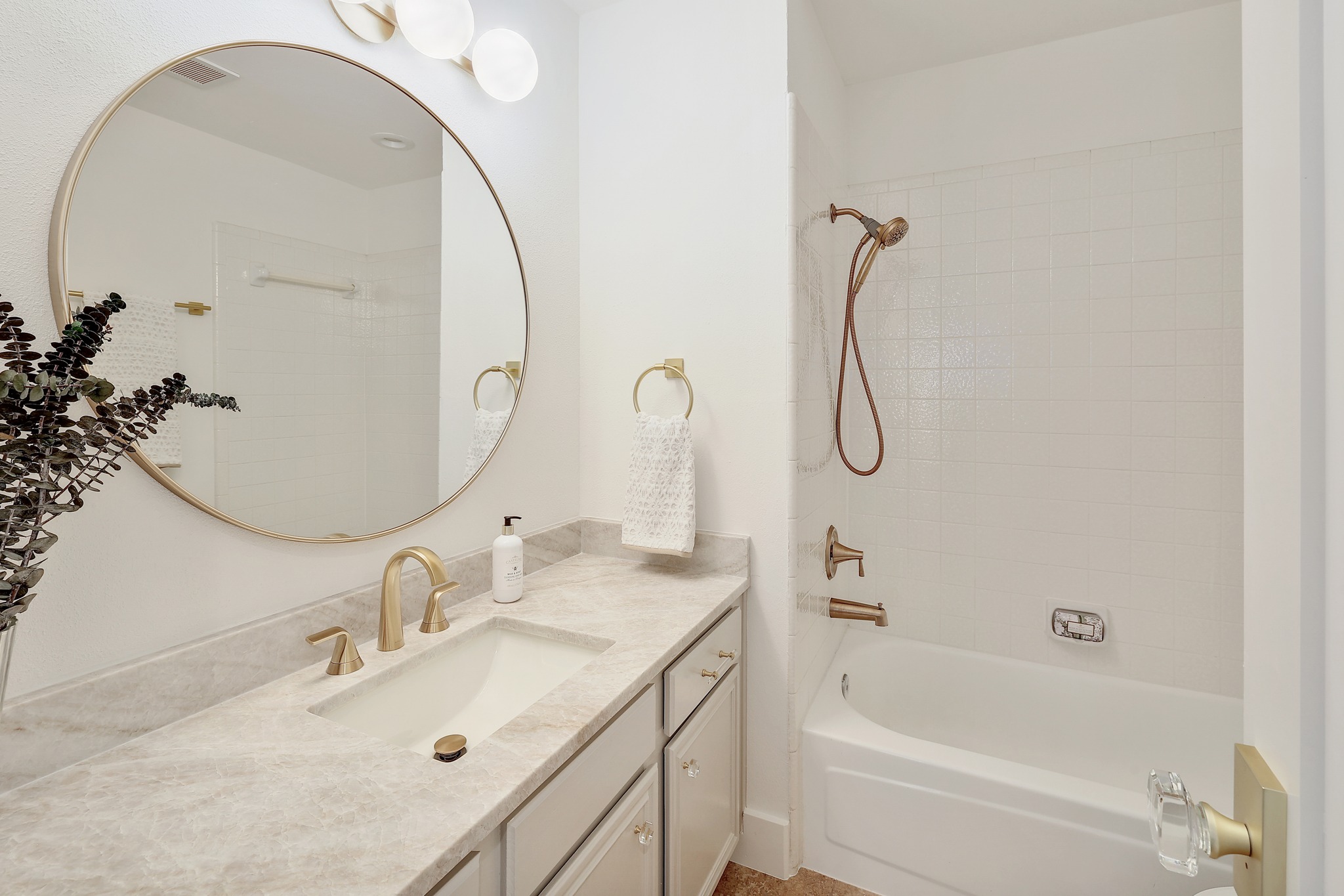 7705 Jester Boulevard Austin, TX 78730 - Photo 21 of 36 A well-appointed bath features a sleek vanity and a tub with a shower combo, all illuminated by contemporary lighting.