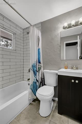 513 Huron Road Colorado Springs, CO 80910 - Photo 20 of 26 updated bathroom with subway tile tub/shower surround