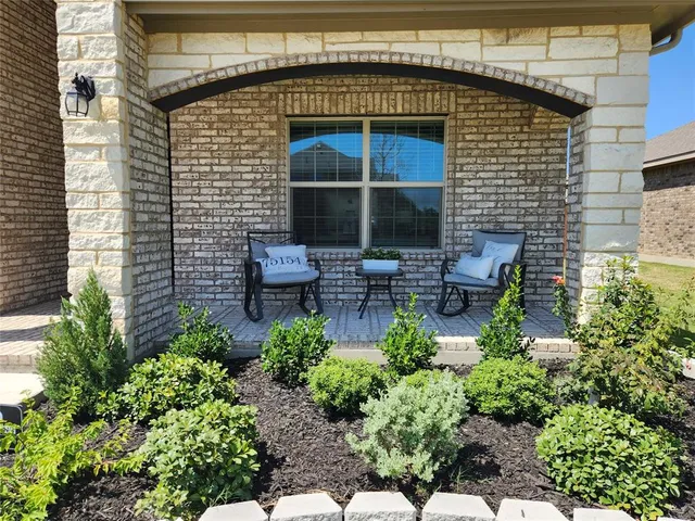 a view of a chair and table in the balcony