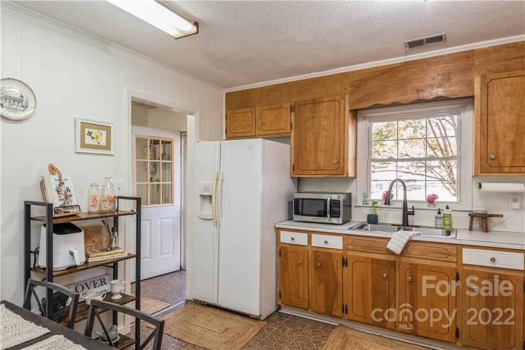 1152 Faulkner Road, Unit 1 Clover, SC 29710 - Photo 13 of 26 a kitchen with stainless steel appliances granite countertop a refrigerator a sink a stove and white cabinets