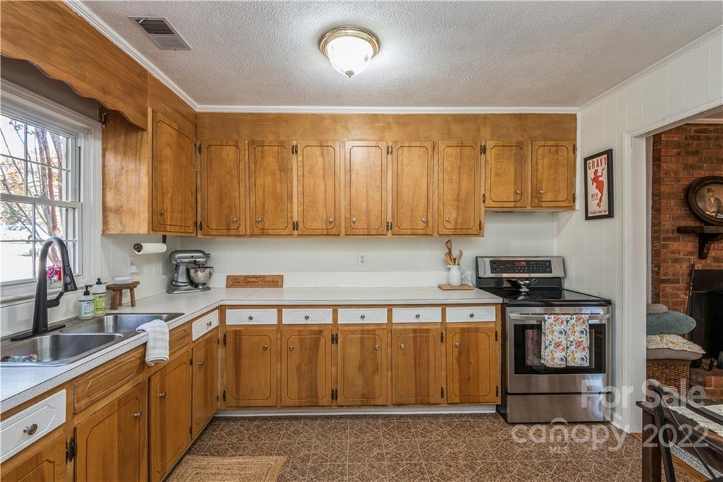 1152 Faulkner Road, Unit 1 Clover, SC 29710 - Photo 14 of 26 a kitchen with stainless steel appliances granite countertop a stove a sink and a microwave