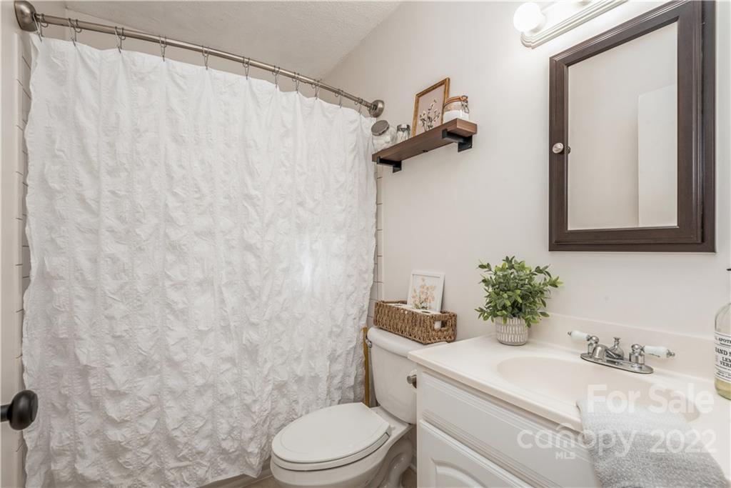 1152 Faulkner Road, Unit 1 Clover, SC 29710 - Photo 20 of 26 a bathroom with a granite countertop sink mirror vanity and toilet