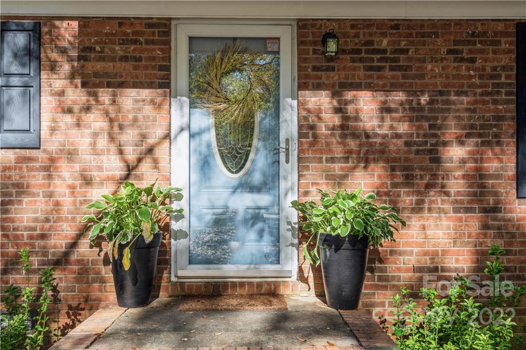 1152 Faulkner Road, Unit 1 Clover, SC 29710 - Photo 2 of 26 a potted plant in front of a glass door