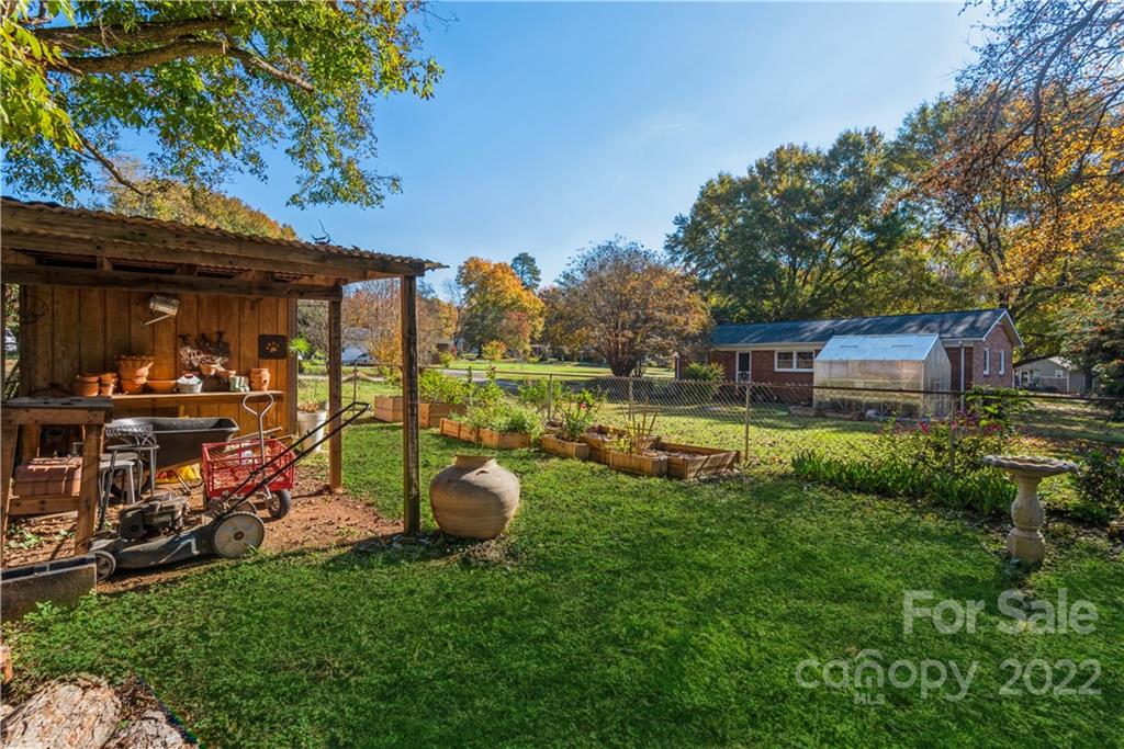 1152 Faulkner Road, Unit 1 Clover, SC 29710 - Photo 23 of 26 a view of a chair and tables in the back yard of the house