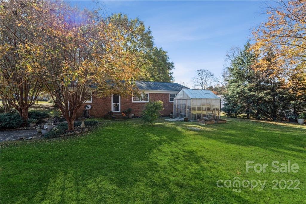 1152 Faulkner Road, Unit 1 Clover, SC 29710 - Photo 6 of 26 a front view of a house with a garden and trees