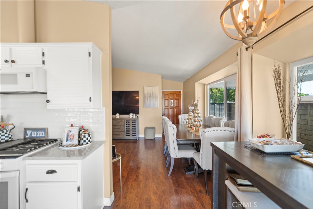 27829 Carnegie Avenue Santa Clarita, CA 91350 - Photo 18 of 46 a kitchen with stainless steel appliances a table and chairs in it