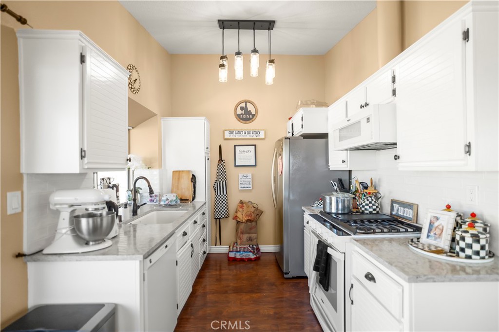 27829 Carnegie Avenue Santa Clarita, CA 91350 - Photo 19 of 46 a kitchen with stainless steel appliances granite countertop a sink stove and refrigerator
