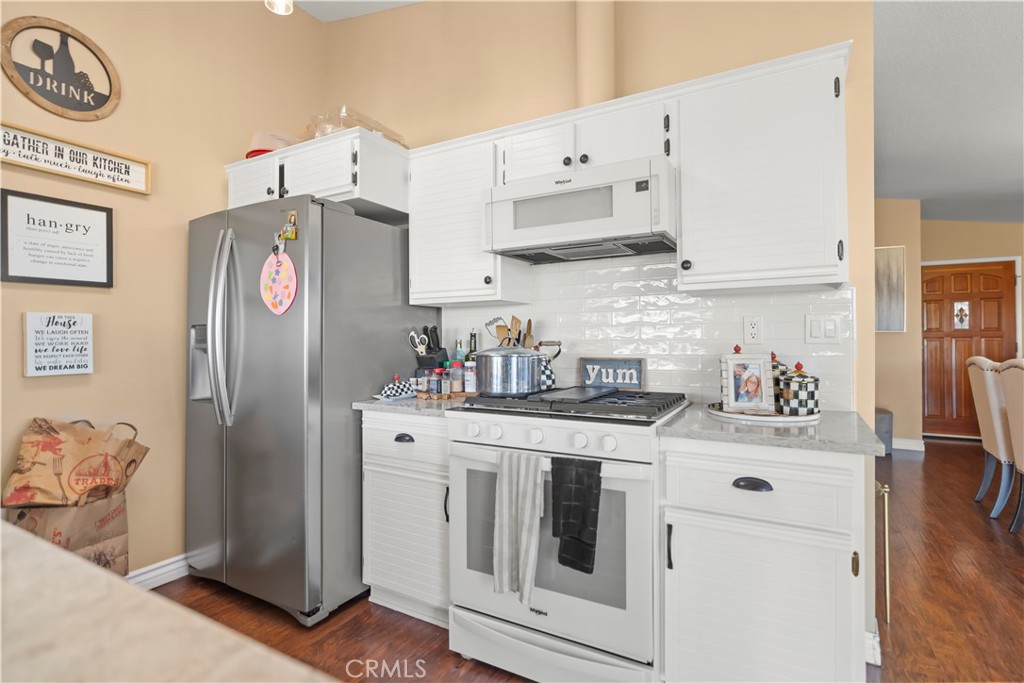27829 Carnegie Avenue Santa Clarita, CA 91350 - Photo 20 of 46 a kitchen with stainless steel appliances granite countertop a refrigerator and a stove top oven