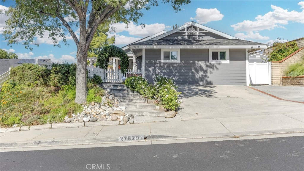 27829 Carnegie Avenue Santa Clarita, CA 91350 - Photo 2 of 46 front view of a house with a bench in front of it