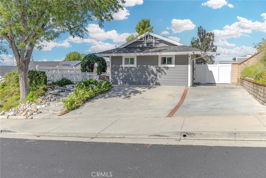 27829 Carnegie Avenue Santa Clarita, CA 91350 - Photo 4 of 46 a front view of a house with a yard and garage