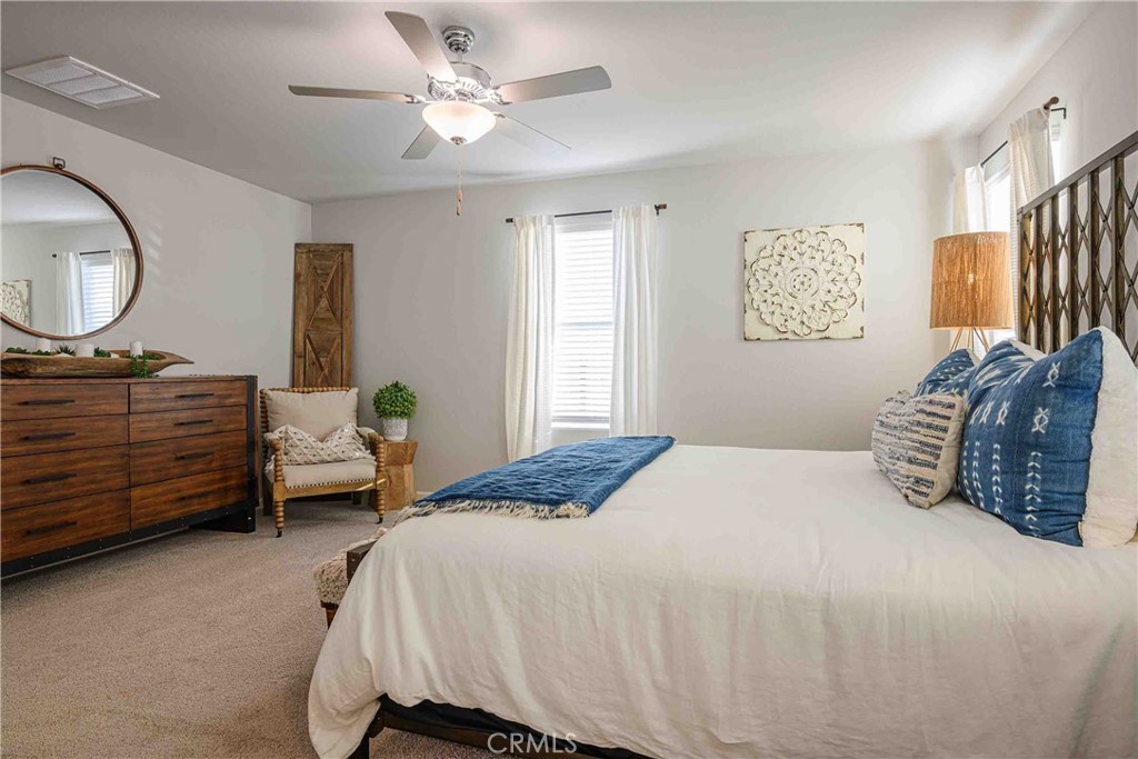64 River Oak Court, Unit 47 SE Merced, CA 95341 - Photo 11 of 18 a bedroom with a bed dresser and a window