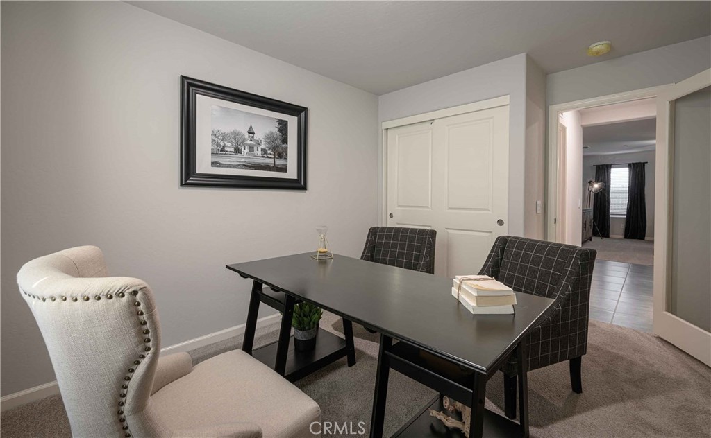 64 River Oak Court, Unit 47 SE Merced, CA 95341 - Photo 17 of 18 a view of a dining room with furniture and wooden floor