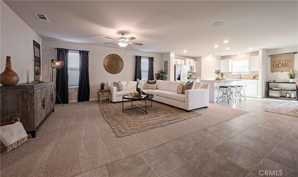 64 River Oak Court, Unit 47 SE Merced, CA 95341 - Photo 8 of 18 a living room with furniture a table and chairs