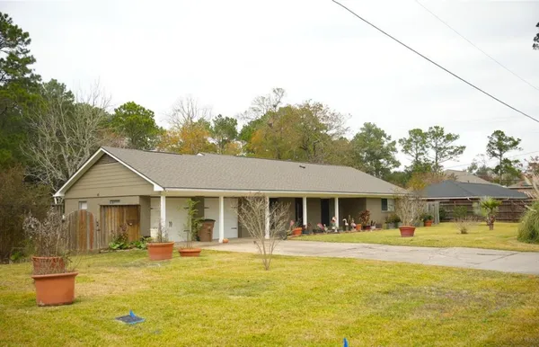 a front view of a house with swimming pool having outdoor seating