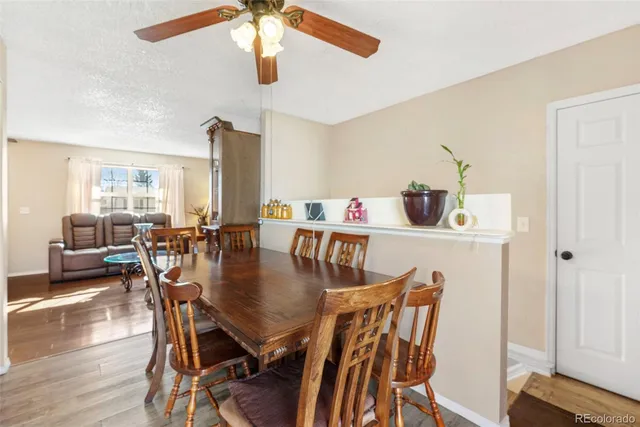 a dining room with furniture and wooden floor