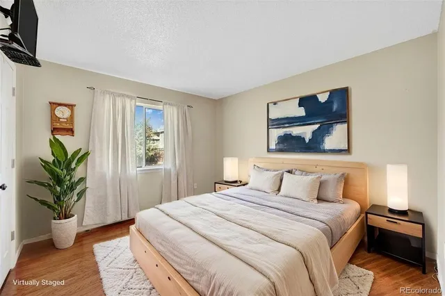 a bedroom with a bed and a painting on the wall