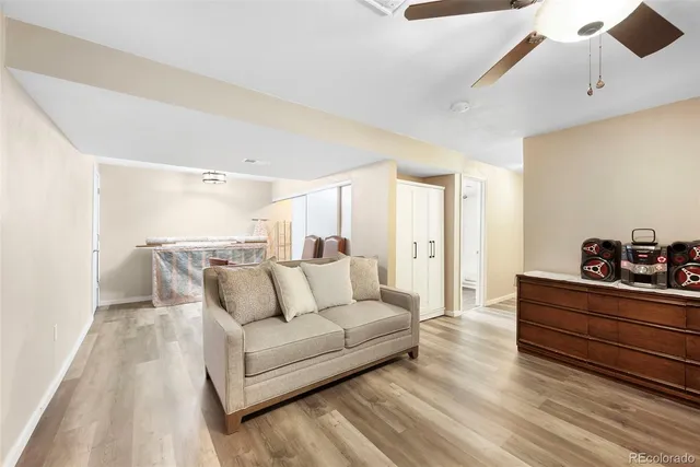 a living room with furniture and a wooden floor