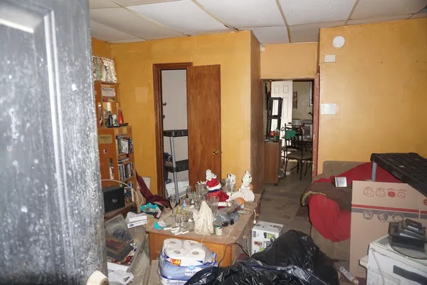 a kitchen with a table chairs and a refrigerator