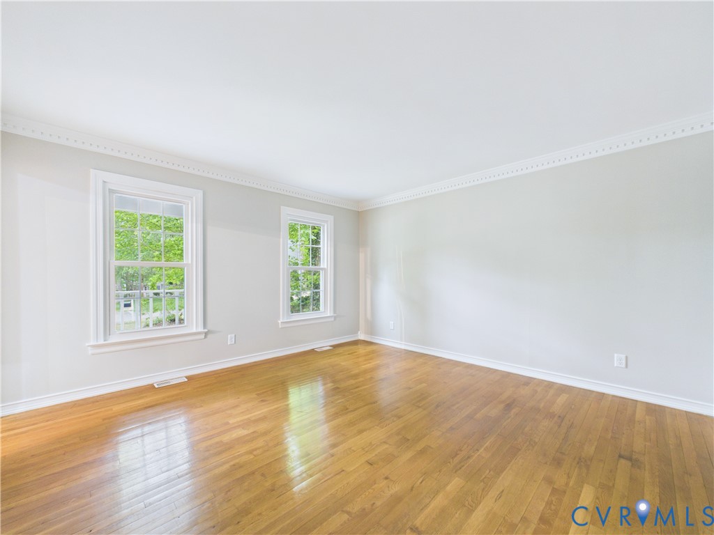 4502 Greyfield Place Chester, VA 23831 - Photo 14 of 40 an empty room with wooden floor and windows