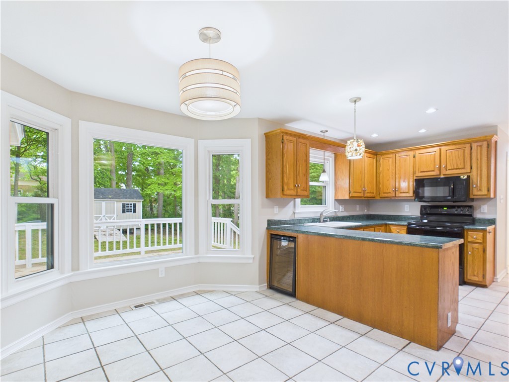 4502 Greyfield Place Chester, VA 23831 - Photo 18 of 40 a large kitchen with granite countertop a stove and a sink