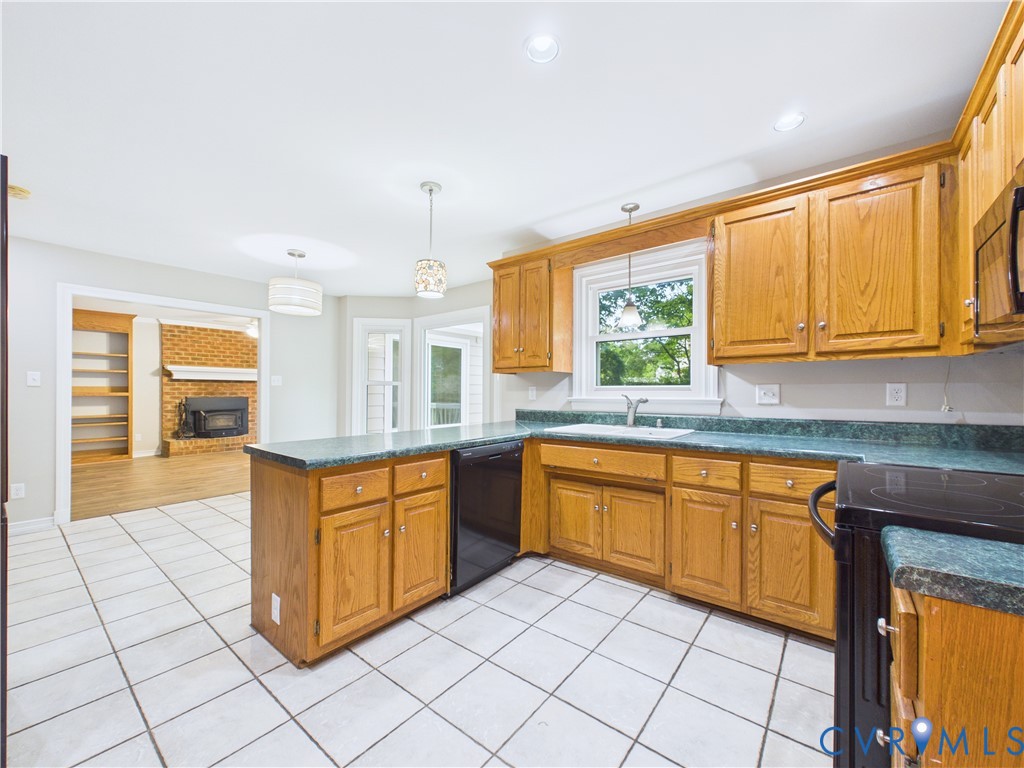 4502 Greyfield Place Chester, VA 23831 - Photo 20 of 40 a kitchen with stainless steel appliances granite countertop a stove a sink and a microwave