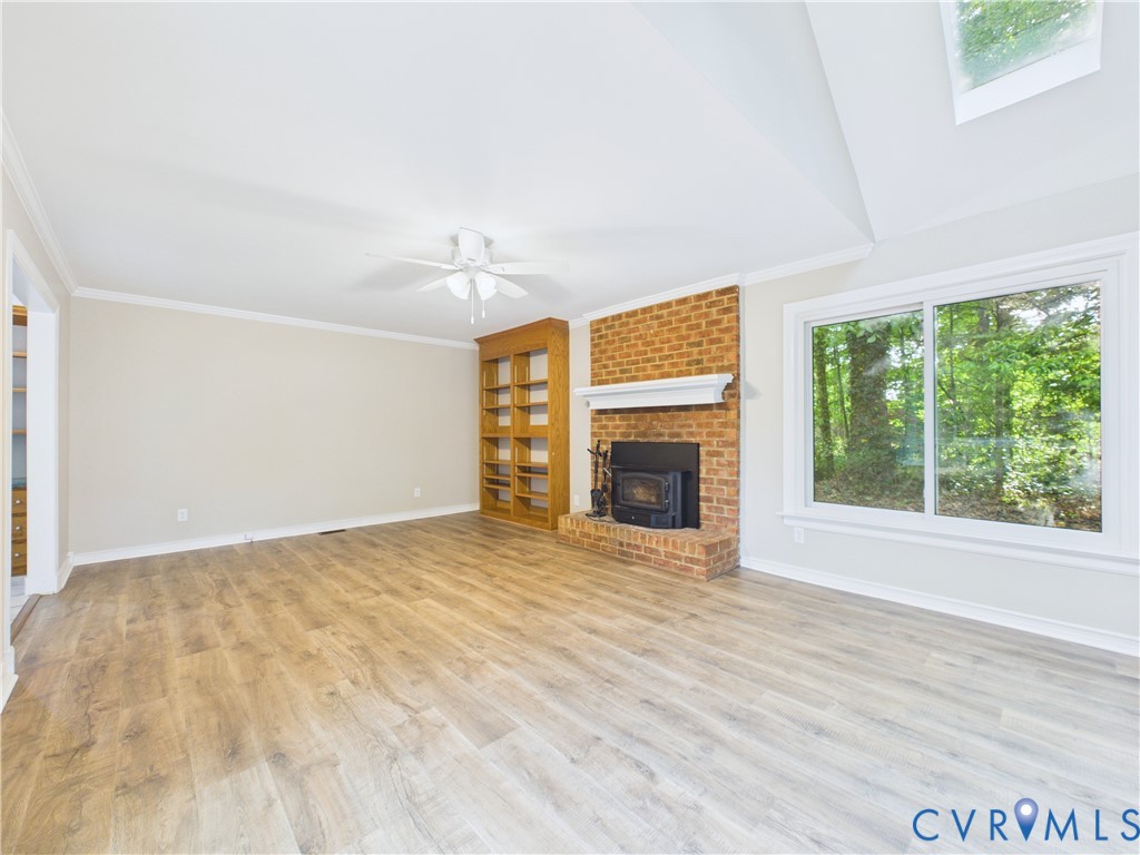 4502 Greyfield Place Chester, VA 23831 - Photo 24 of 40 a view of empty room with wooden floor and fireplace